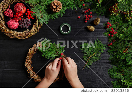 Manufacturer of Christmas decor with their own hands. Christmas wreath for the holiday. The new year celebration. Top view 82015826