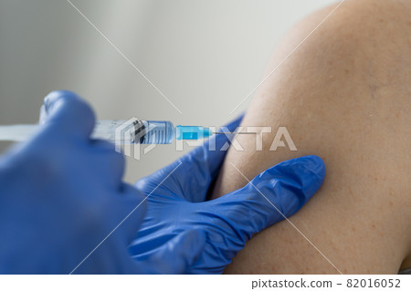 Close up of a Doctor making a vaccination in the shoulder of patient, Flu Vaccination Injection on Arm, coronavirus, Close up of a Doctor making a vaccination in the shoulder of patient, Flu Vaccination Injection on Arm, coronavirus, 82016052