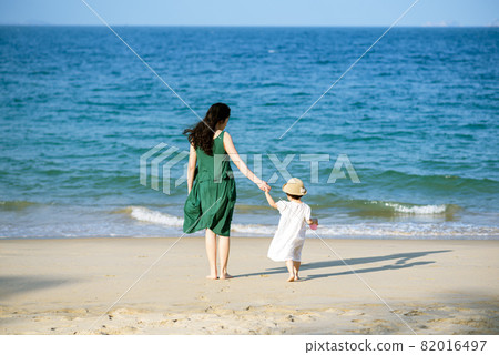 Mother and daughter having fun on the beach Mother and daughter having fun on the beach 82016497