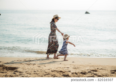 Mother and daughter having fun on the beach Mother and daughter having fun on the beach 82016507