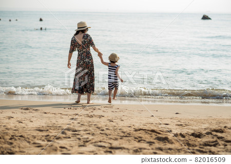 Mother and daughter having fun on the beach Mother and daughter having fun on the beach 82016509