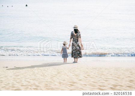 Mother and daughter having fun on the beach Mother and daughter having fun on the beach 82016538