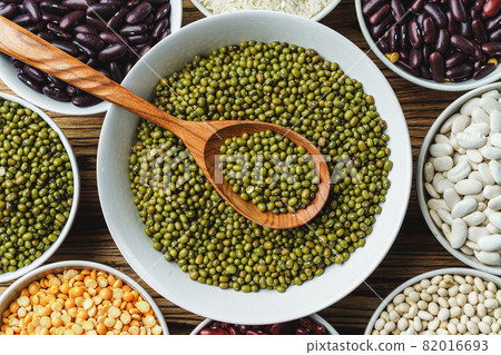 Assortment of beans on wooden background. Close up. 82016693