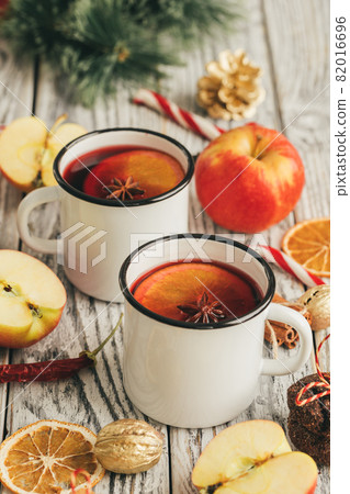 White cups of glint wine on wooden table close up White cups of glint wine on wooden table close up 82016696