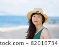 Young woman on sandy beach 82016734