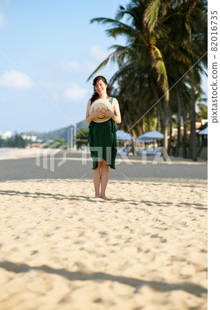 Young woman on sandy beach 82016735