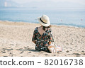 Young woman on sandy beach 82016738