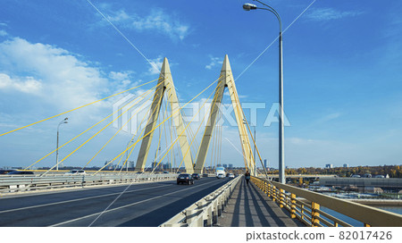 Millennium Bridge in Kazan, Russia. A man walking on the bridge and cars driving. Millennium Bridge in Kazan, Russia. A man walking on the bridge and cars driving. 82017426