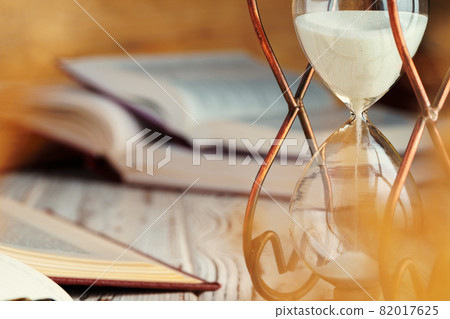 Hourglass with sand close up on wooden background Hourglass with sand close up on wooden background 82017625