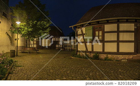 View of the courtyard of the historical museum of the city of Walldorf in hesse with surrounding half-timbered houses during the sunset View of the courtyard of the historical museum of the city of Walldorf in hesse with surrounding half-timbered houses during the sunset 82018209
