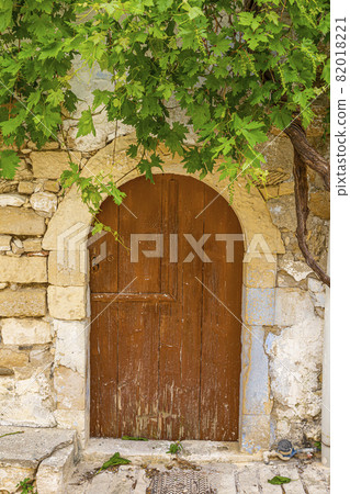 Old and ruinous door in a old greek village during daytime 82018221