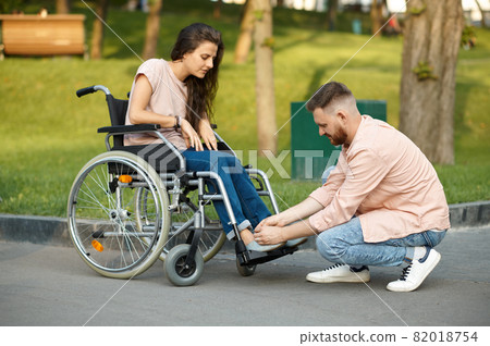 Love couple, care for disabled woman in wheelchair Love couple, care for disabled woman in wheelchair 82018754