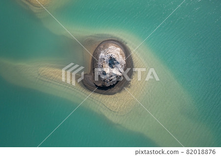 Drone view of the turquoise lake formed as a result of mining waste Drone view of the turquoise lake formed as a result of mining waste 82018876