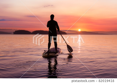 Adventurous Caucasian Adult Woman on a Stand Up Paddle Board 82019418