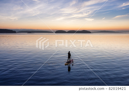 Adventurous Caucasian Adult Woman on a Stand Up Paddle Board Adventurous Caucasian Adult Woman on a Stand Up Paddle Board 82019421