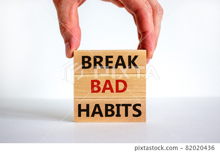 Break bad habits symbol. Wooden blocks with words 'break bad habits'. Male hand. Beautiful white background, copy space. Business, psychological and break bad habits concept. Break bad habits symbol. Wooden blocks with words 'break bad habits'. Male hand. Beautiful white background, copy space. Business, psychological and break bad habits concept. 82020436