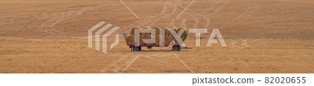 Balls of straw over the trailer, long shot 82020655
