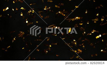 Abstract falling gold confetti on black background. 82020814