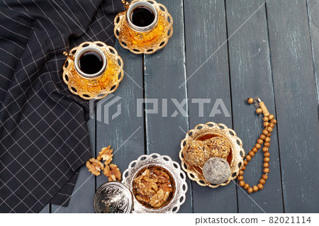 Nut balls dessert served with coffee on dark wooden table, top view 82021114