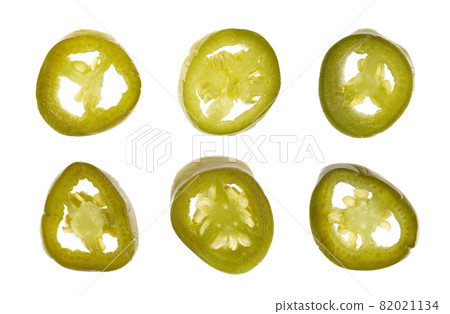 Pickled jalapeno pepper, isolated on white background. Slices of preserved hot serrano. Close up. Top view. 82021134