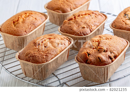 Freshly baked mini loaves of cupcakes with raisins. Freshly baked mini loaves of cupcakes with raisins. 82021235