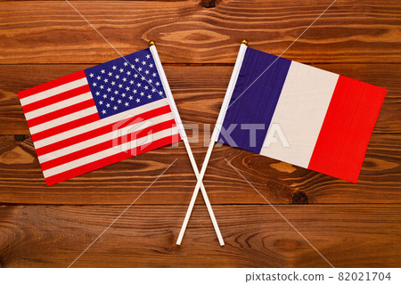 Flag of USA and flag of France crossed with each other. USA vs France. The image illustrates the relationship between countries. Photography for video news on TV and articles on the Internet and media Flag of USA and flag of France crossed with each other. USA vs France. The image illustrates the relationship between countries. Photography for video news on TV and articles on the Internet and media 82021704