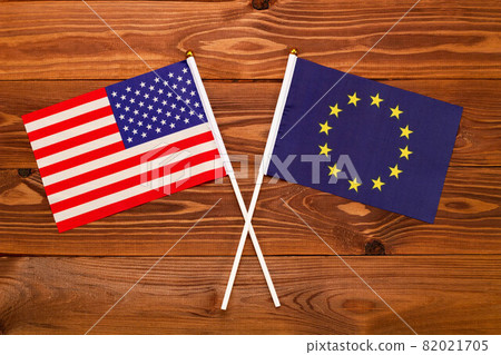 Flag of USA and flag of European Union crossed with each other. USA vs Europe EU. The image illustrates the relationship between countries. Photography for video news on TV and articles on the Interne 82021705
