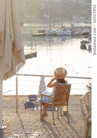 girl tourist stands on the embankment of the sea in the bay of paleokastritsa girl tourist stands on the embankment of the sea in the bay of paleokastritsa 82023952