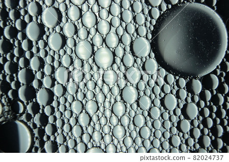 abstract macro background of oil circles floating over water surface . 82024737