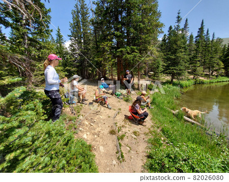 Hikers on shore of Hassell Lake in Arapaho National Forest, Colorado. Hikers on shore of Hassell Lake in Arapaho National Forest, Colorado. 82026080