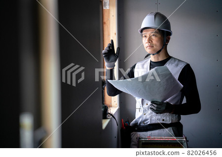 Male worker checking the drawing 82026456