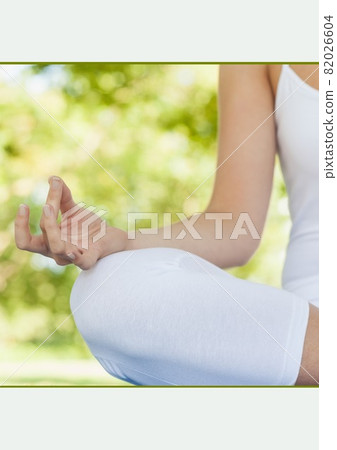 Mid section of a woman practicing yoga in the garden against white background 82026604