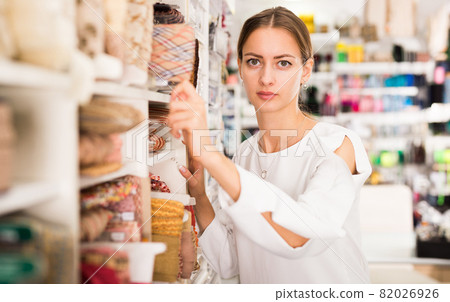 Woman choosing colorful ribbons Woman choosing colorful ribbons 82026926