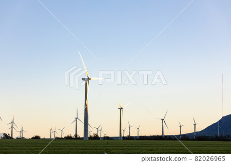 General view of wind turbines in countryside landscape with cloudless sky 82026965