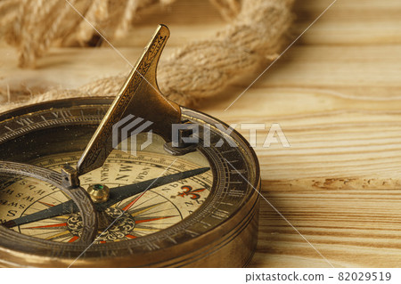 Ship rope and compass on wooden background 82029519