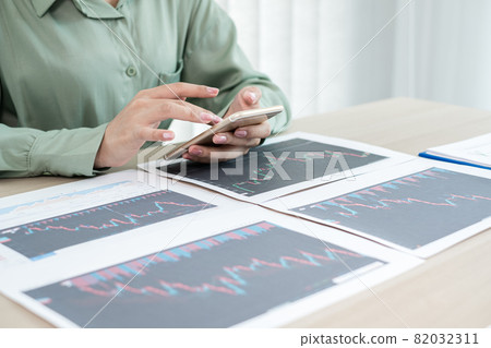 Hand of businesswoman are planning business investments related to shares By analyzing and calculating the stock market for marketing profits 82032311