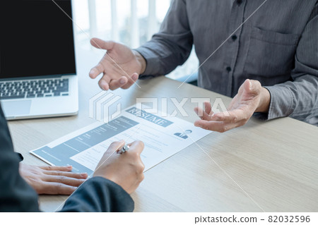 Business people hold a resume and talk to job applicants for job interviews about careers and Her personal history in the company. Recruitment concepts Business people hold a resume and talk to job applicants for job interviews about careers and Her personal history in the company. Recruitment concepts 82032596