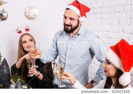 Christmas party cheerful friends at having drink and fun 82033160