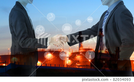 Two petrochemical contractors closing a deal in front of an oil refinary,Future factory plant and energy industry Oil, gas and petrochemical refinery factory Two petrochemical contractors closing a deal in front of an oil refinary,Future factory plant and energy industry Oil, gas and petrochemical refinery factory 82034093