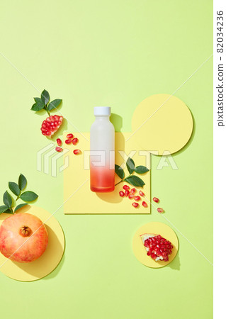 Empty blank bottle containing organic pomegranate seed oil extract on living coral background. Cosmetic natural serum, skincare, essential oil products. Beauty product branding mock-up. Flat lay. Empty blank bottle containing organic pomegranate seed oil extract on living coral background. Cosmetic natural serum, skincare, essential oil products. Beauty product branding mock-up. Flat lay. 82034236