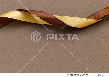 Two ribbons, an adult-like brown background, a gift image Two ribbons, an adult-like brown background, a gift image 82035528