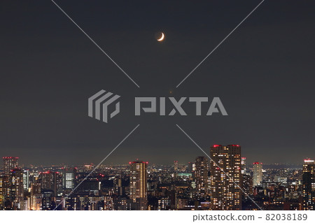 Crescent moon over Tokyo as seen from a tower mansion in Shibaura Island 82038189