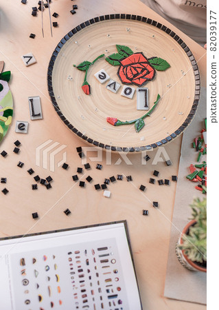 Workplace of mosaic maker: material and tools on wooden table Workplace of mosaic maker: material and tools on wooden table 82039177