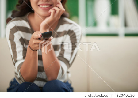 Woman Changing Channels on TV Woman Changing Channels on TV 82040136