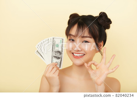 Pretty Woman Holding Money 82040234