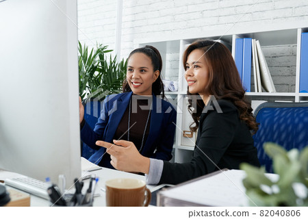 Entrepreneurs Discussing Presentation on Computer Screen 82040806