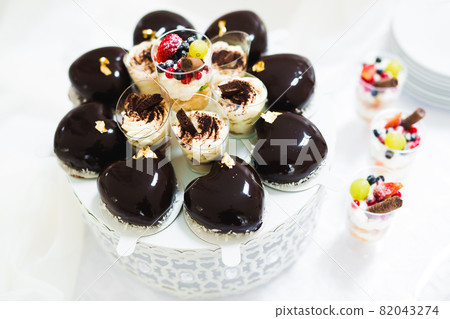 Delicious sweets on wedding candy buffet with desserts, cupcakes 82043274