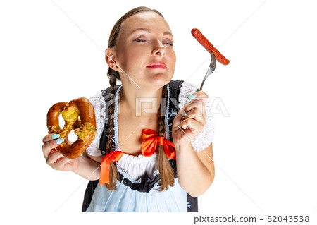 Close-up happy Oktoberfest woman, waitress wearing a traditional Bavarian or german dirndl isolated on white studio background. 82043538