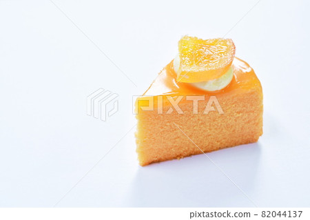 orange cake with cream topping fruit on white background 82044137