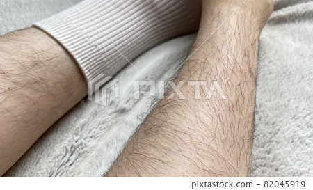 Female shin in white socks with lots of unwanted hair 82045919